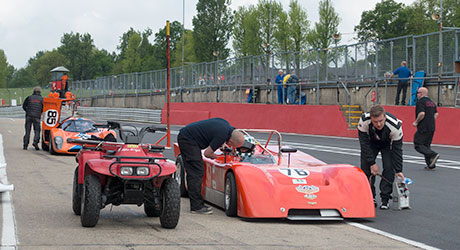 Pit lane view showing Chevron B19 1971 and Chevron B16 1970 in background