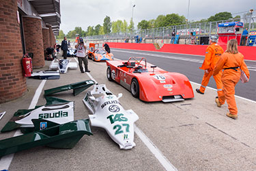 Pit lane view showing bodywork from Williams FW07 1980, Chevron B19 1971 and Chevron B16 1970 in background